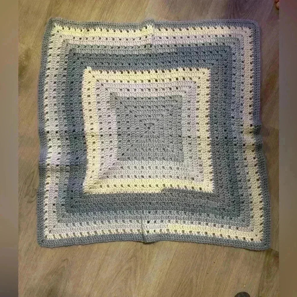 Handmade crocheted baby afghan blanket in grays with blue hues & cream